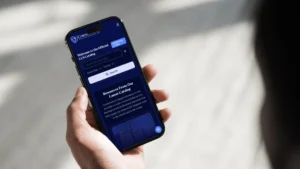 Mobile screen showing a dark blue CCS Catalog webpage with a welcome message and search bar on a smartphone.