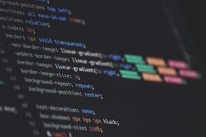 Close-up of a dark screen showing colorful CSS code with properties like z-index and border highlighting.